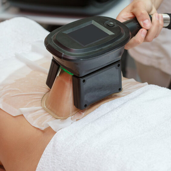 Woman getting cryolipolysis fat treatment procedure in professional cosmetic cabinet or spa center, closeup